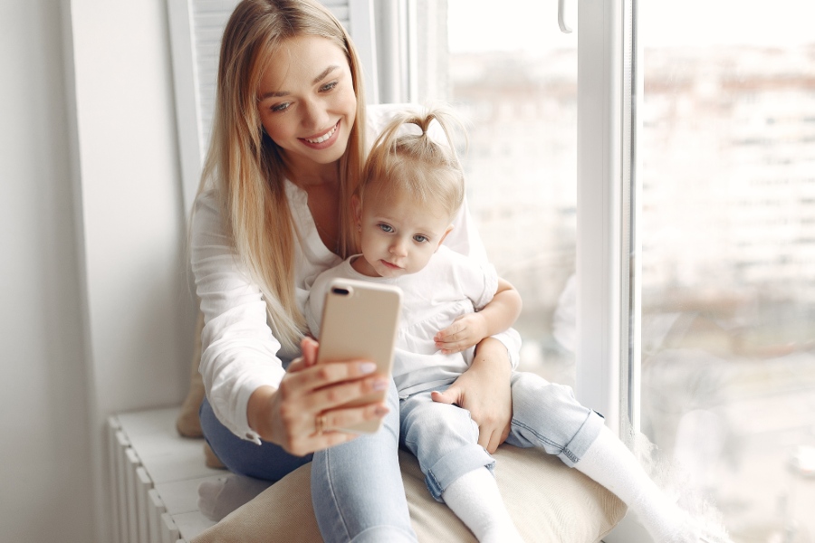 https://www.bebe9.com/media//wysiwyg/contact/woman-uses-phone-mother-white-shirt-is-playing-with-her-daughter-family-has-fun-weekends_1_.jpg